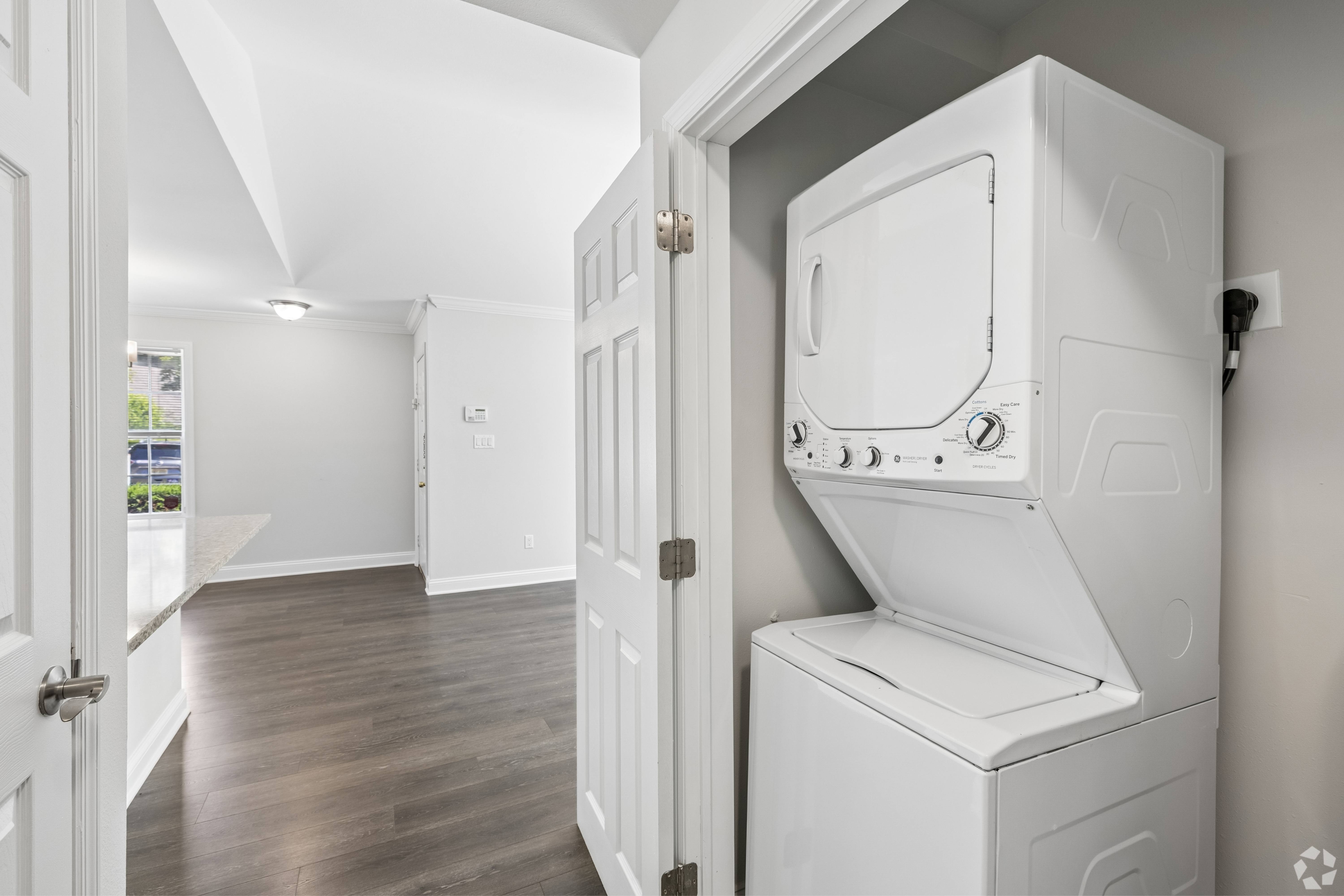 A white washing machine and dryer in a laundry room.